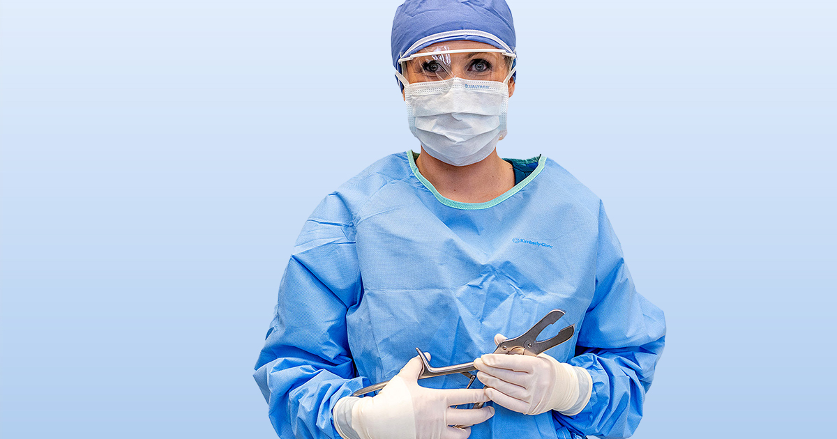 Surgical Technician holding tools for surgery