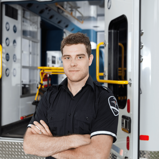 Emergency Medical Technician in front of ambulance