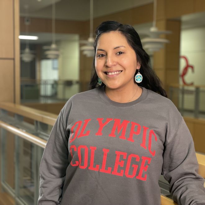 Smiling student in gray Olympic College sweatshirt, in Bldg. 4
