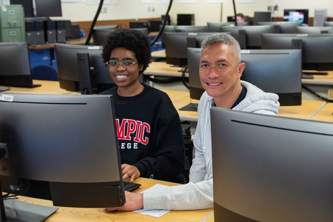 Students sitting behind computers in classroom