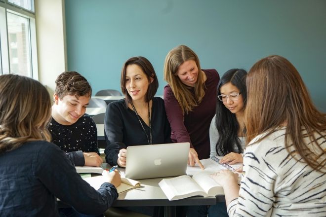Faculty with students in classroom. 