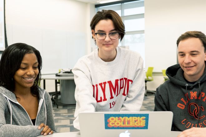 Three students at a laptop.