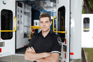 Emergency Medical Technician in front of ambulance