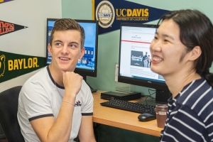 Male and female students at computer.