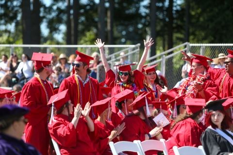 Group of Olympic College students in red regalia at graduation