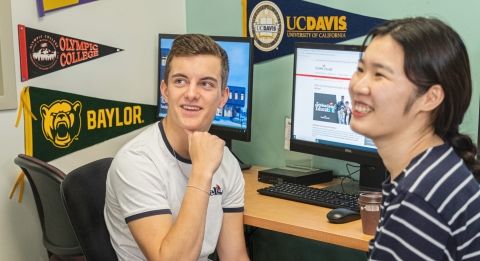 Male and female students at computer.